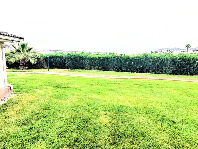 Expansive lawn with lush, manicured turf and mature landscaping