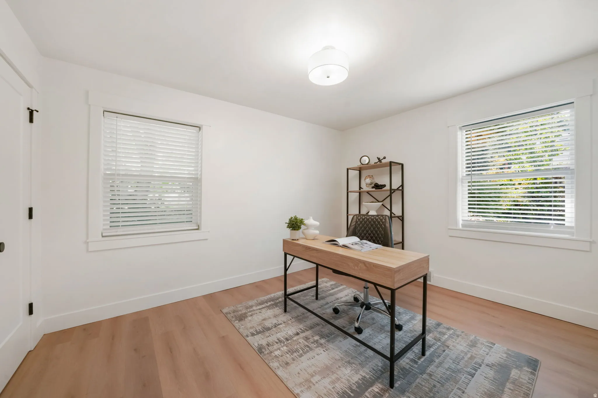 Wood-finish flooring, white walls, and a semi-flush mount ceiling light fixture