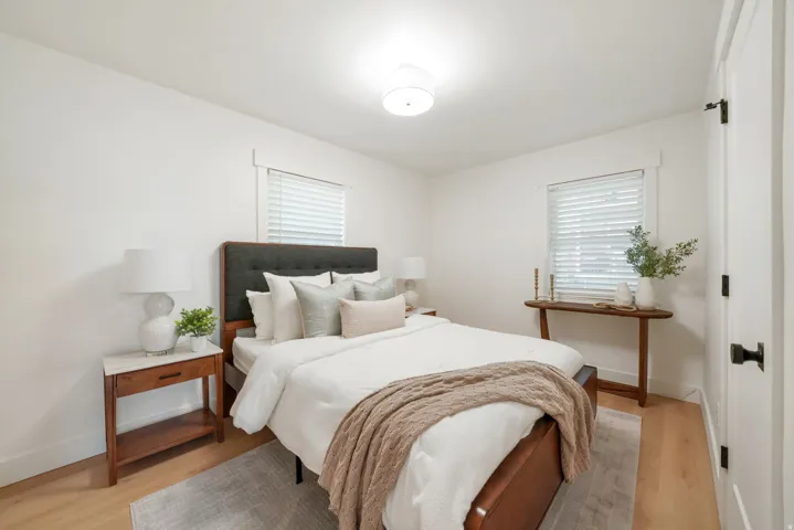 Wood-finish flooring, white walls, and a contemporary ceiling light fixture