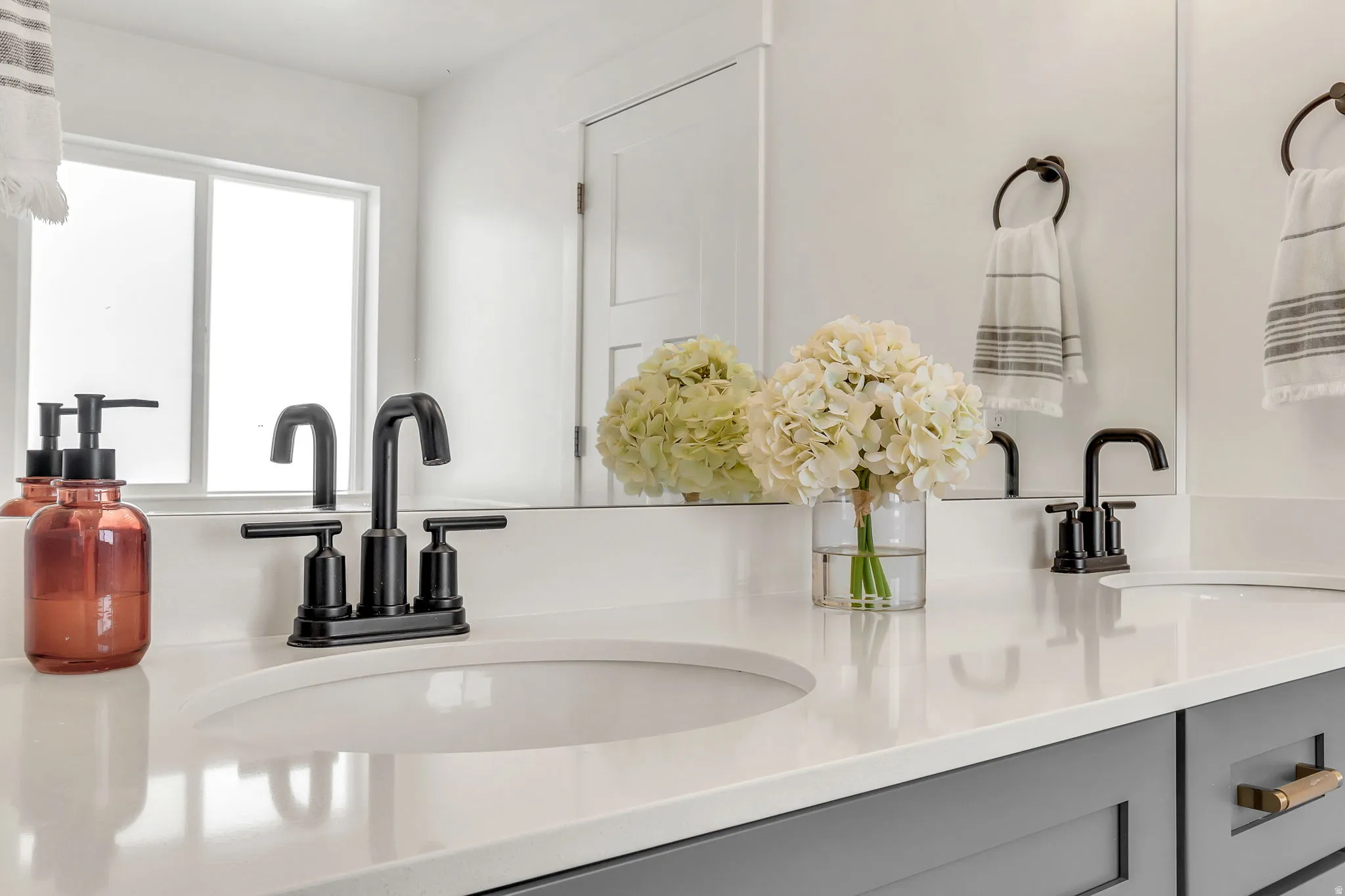 Dual undermount sinks set within a white solid surface countertop
