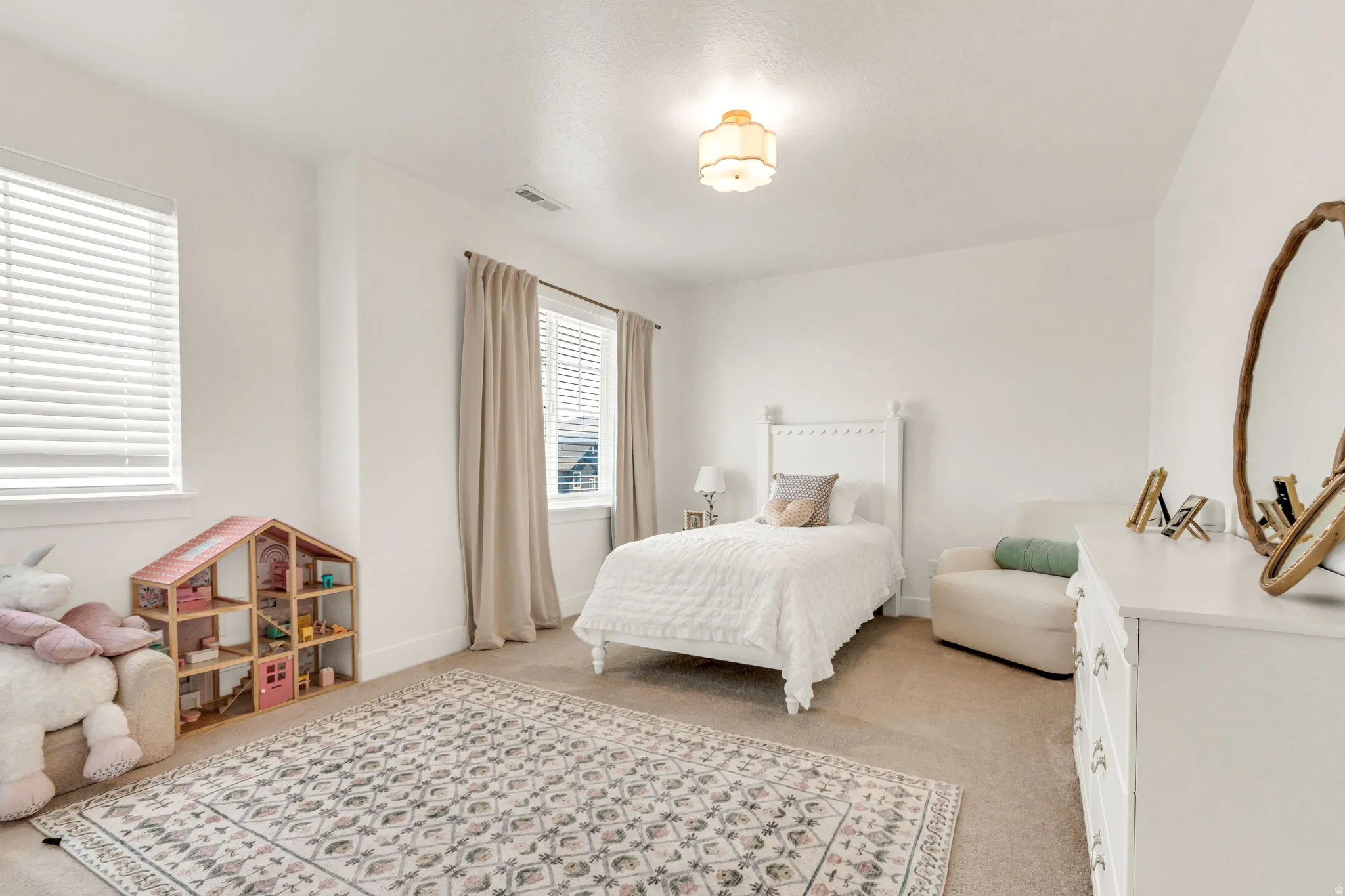Bright interior room featuring neutral-toned carpet flooring and white painted walls