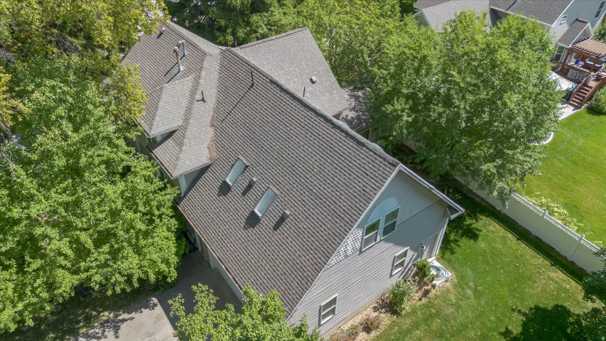 Multi-level roofline featuring dormer windows and multiple skylights