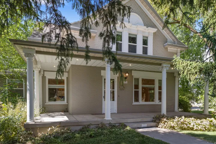Inviting front porch featuring substantial columns and recessed lighting