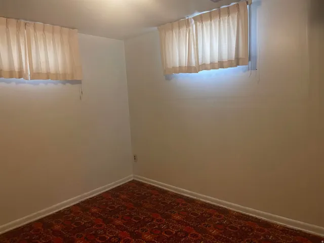 White walls with a patterned carpet floor