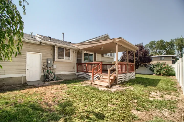 Charming single-story home featuring a spacious covered porch with wood railings and structural posts, ideal for outdoor entertaining