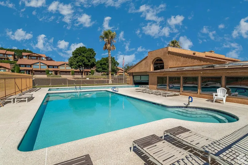 View of outdoor fenced pools from Zillow