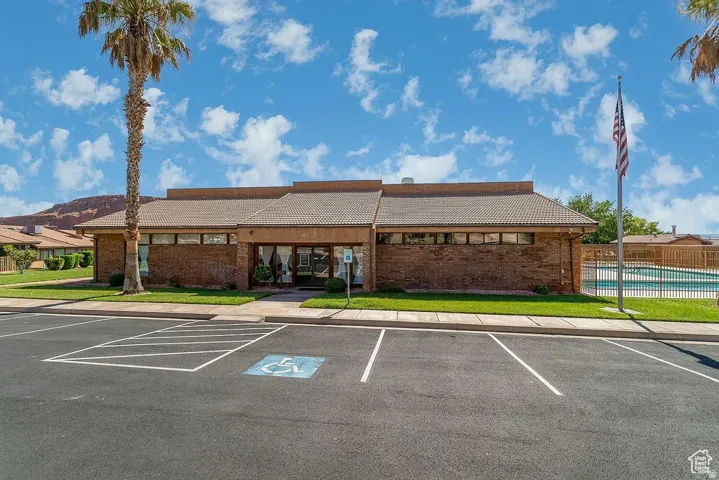View of clubhouse and fenced community pool from Zillow