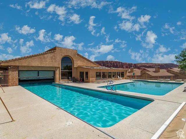 View of outdoor fenced pools from Zillow