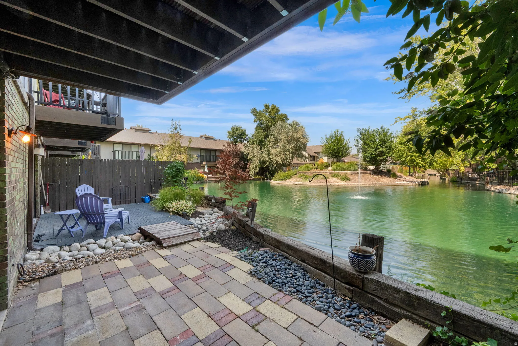 Expansive paver patio with a stone-lined garden bed