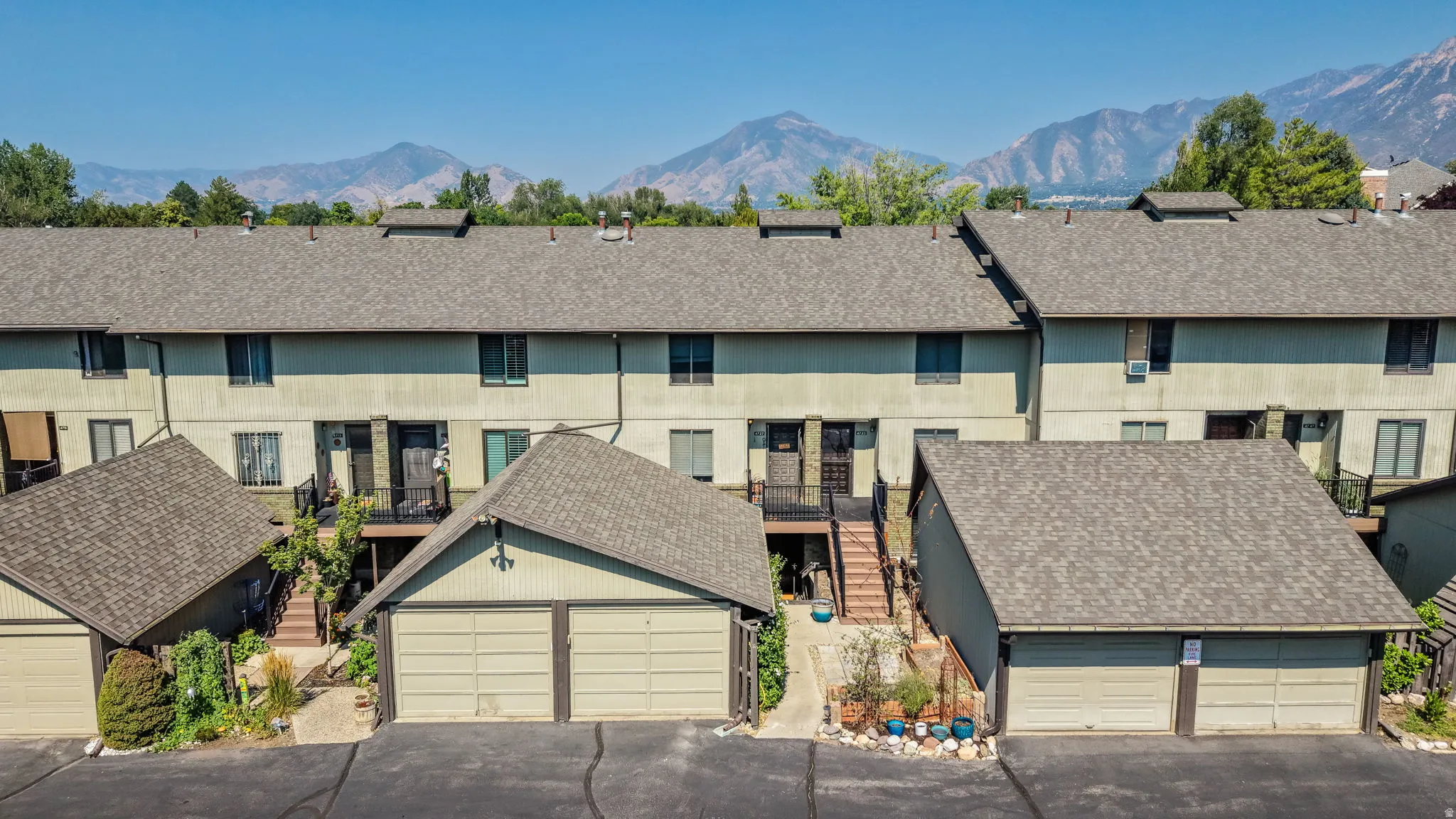 Townhome style residences featuring multiple levels, attached garages, and private balconies