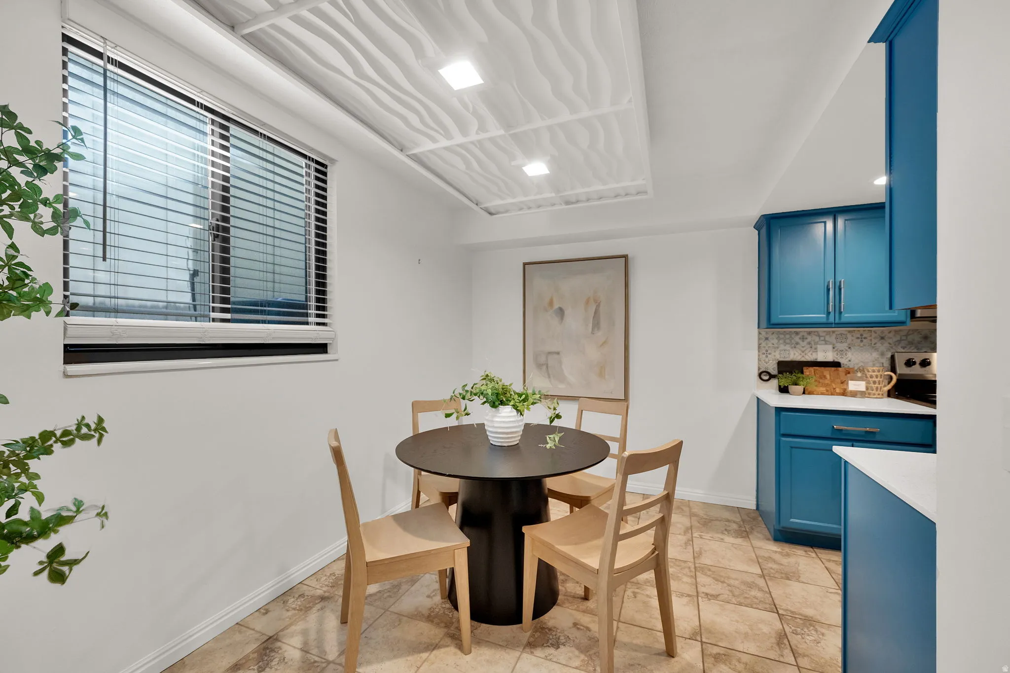 Kitchenette with blue cabinetry, white countertops, tile flooring, and recessed lighting