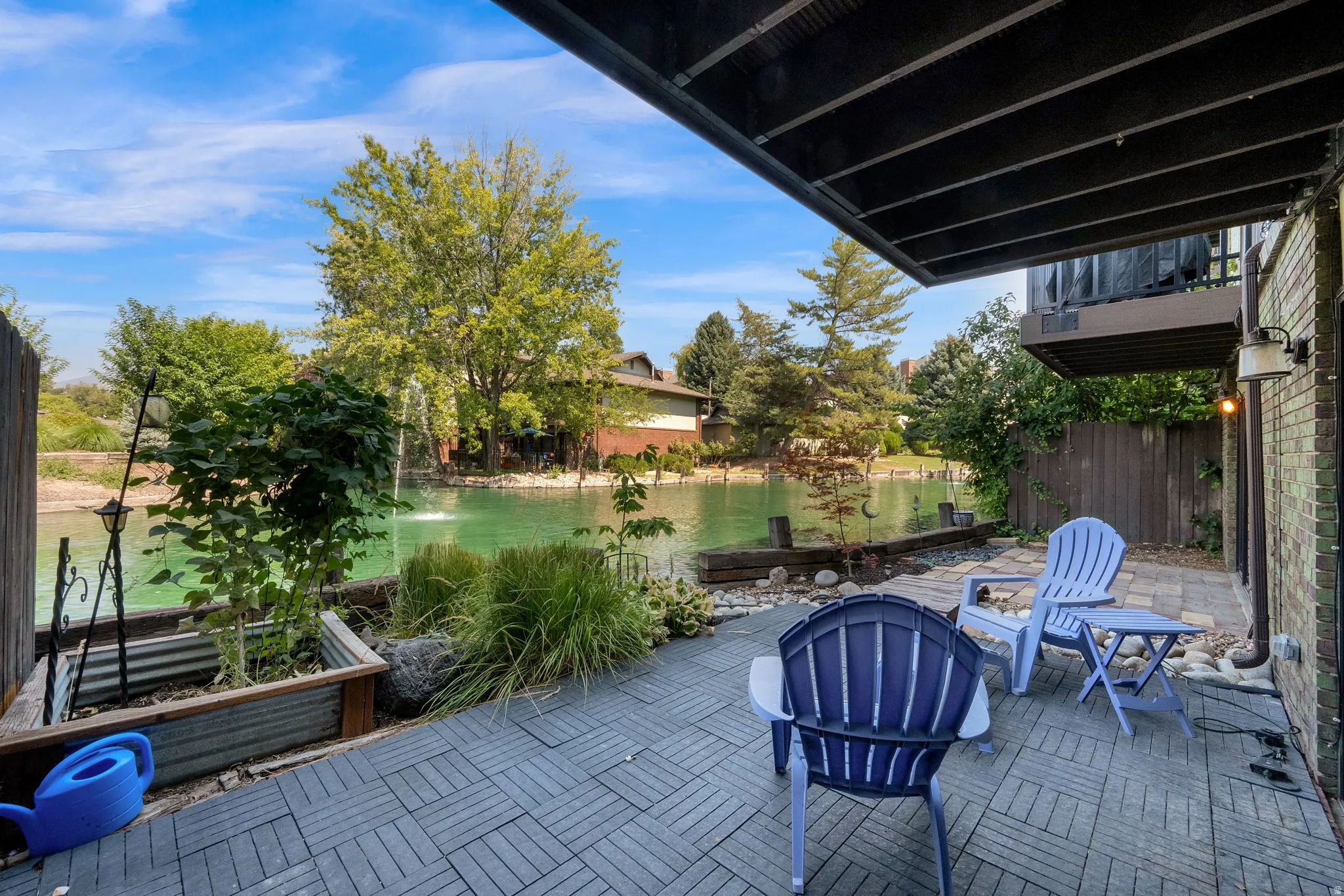 Hardscaping patio with a water feature, stone accents, and built-in planters