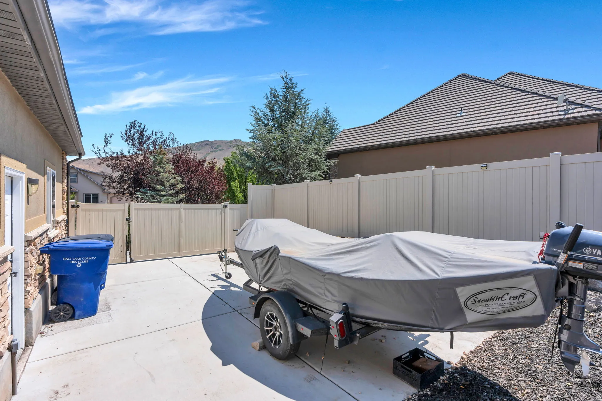 Paved side yard with privacy fencing and double gate access