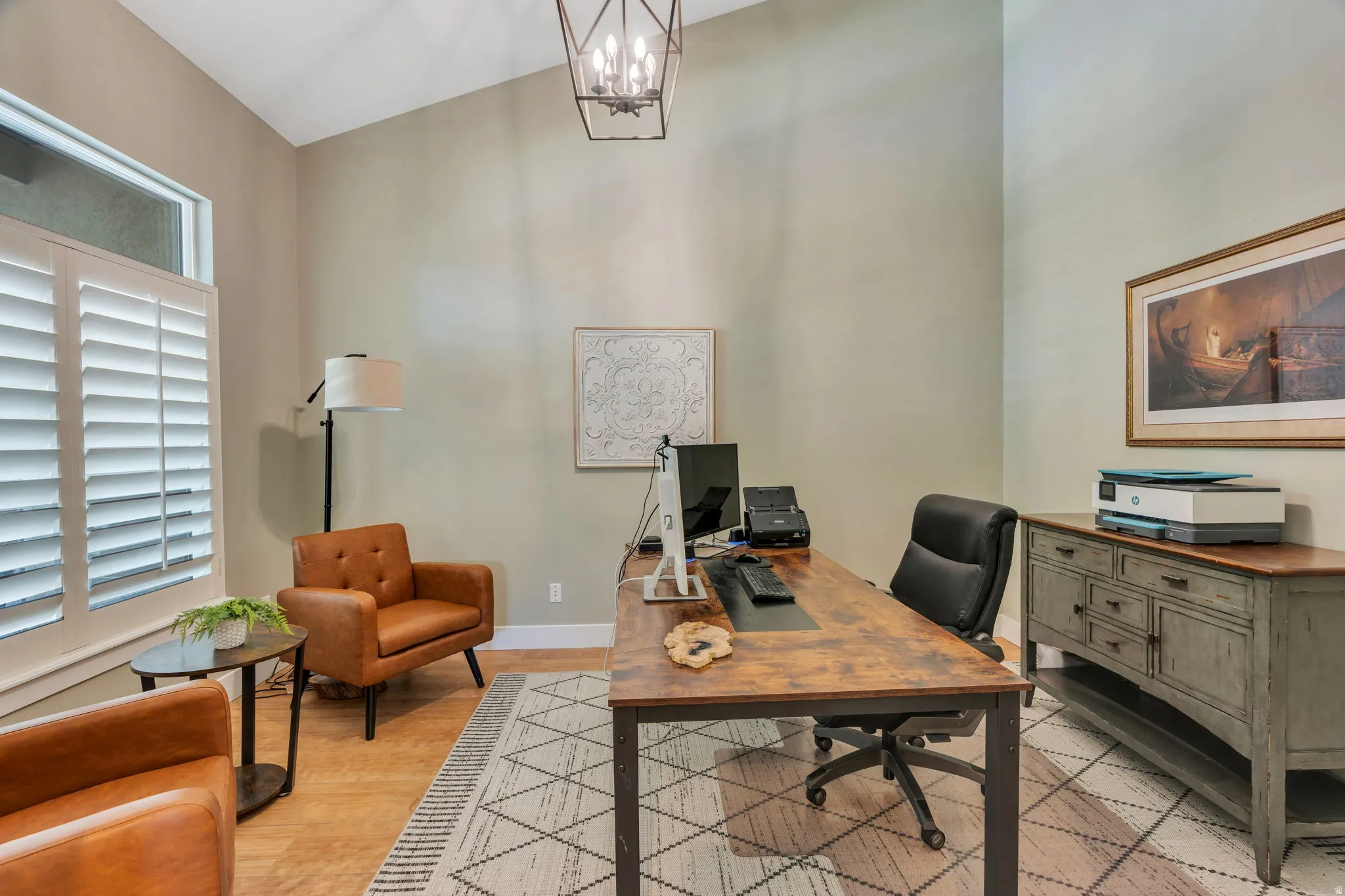 Vaulted ceiling with a geometric chandelier, wood-finish flooring, and plantation shutters