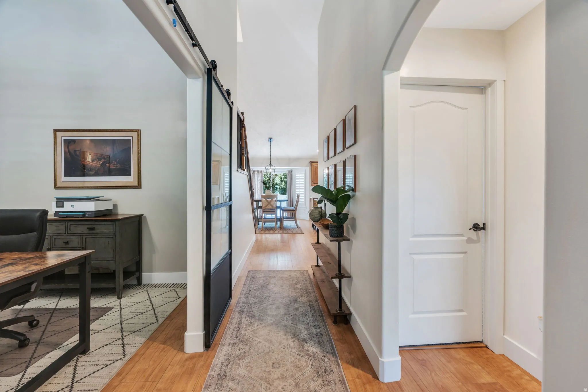 Wood-finish flooring extending through an arched entryway