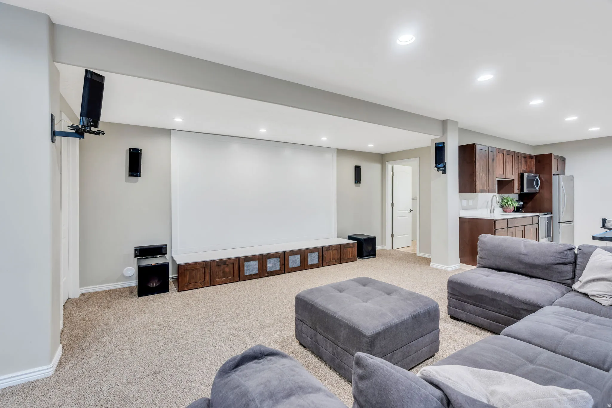 Entertainment space featuring a large projection screen and built-in media console