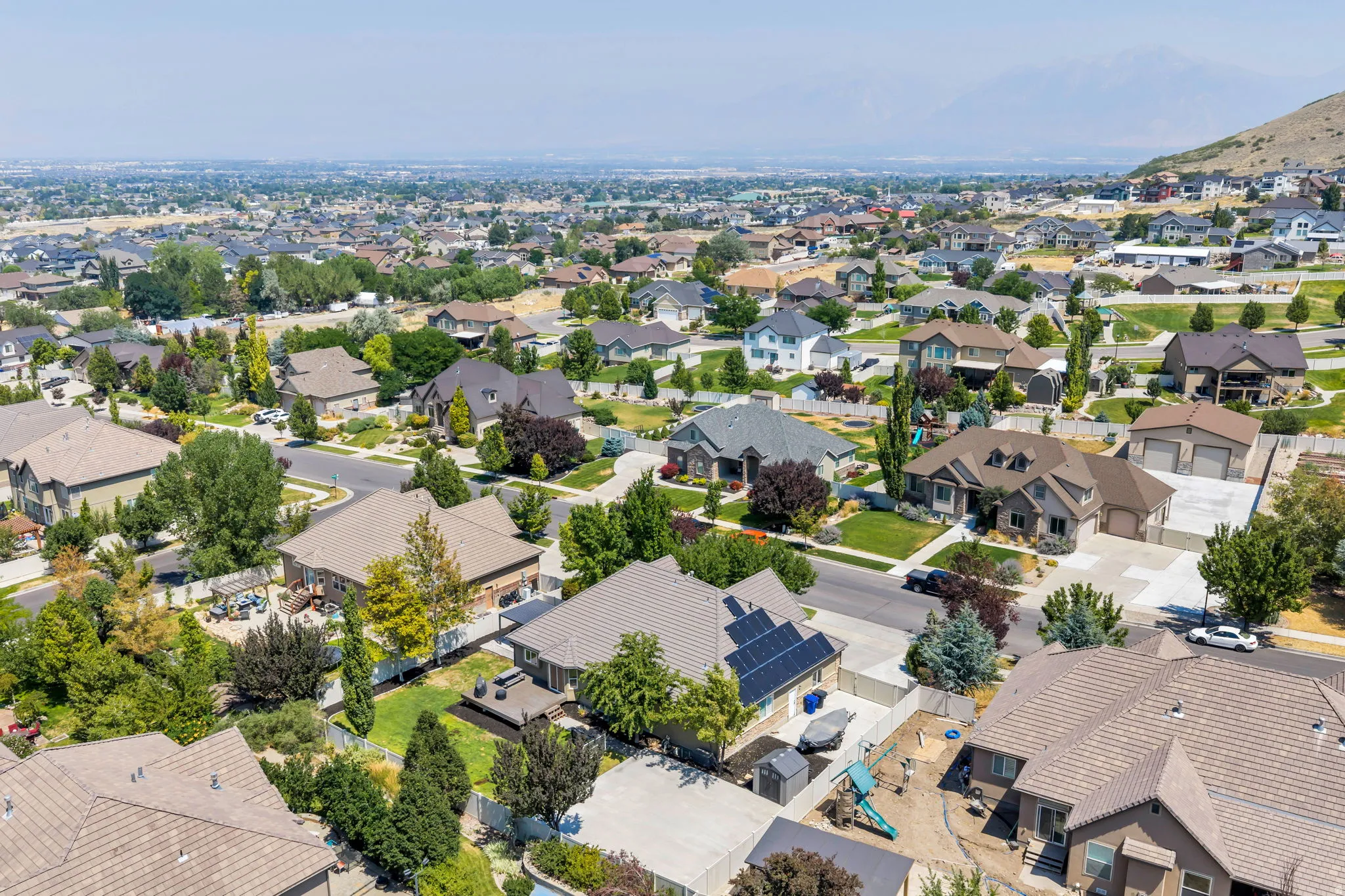 Aerial view of a residential neighborhood with varied architectural styles and mature landscaping