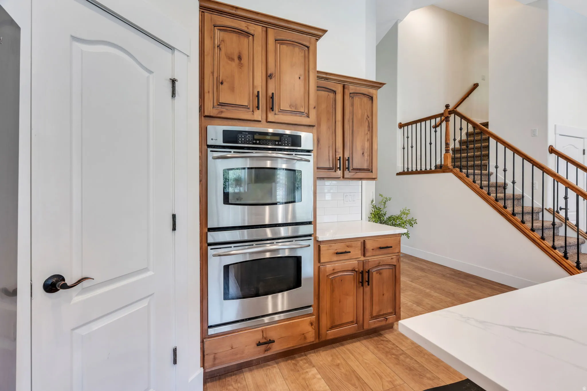 Built-in stainless steel double ovens integrated into wood cabinetry