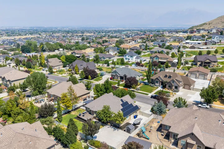 Aerial view of a residential neighborhood with varied architectural styles and mature landscaping