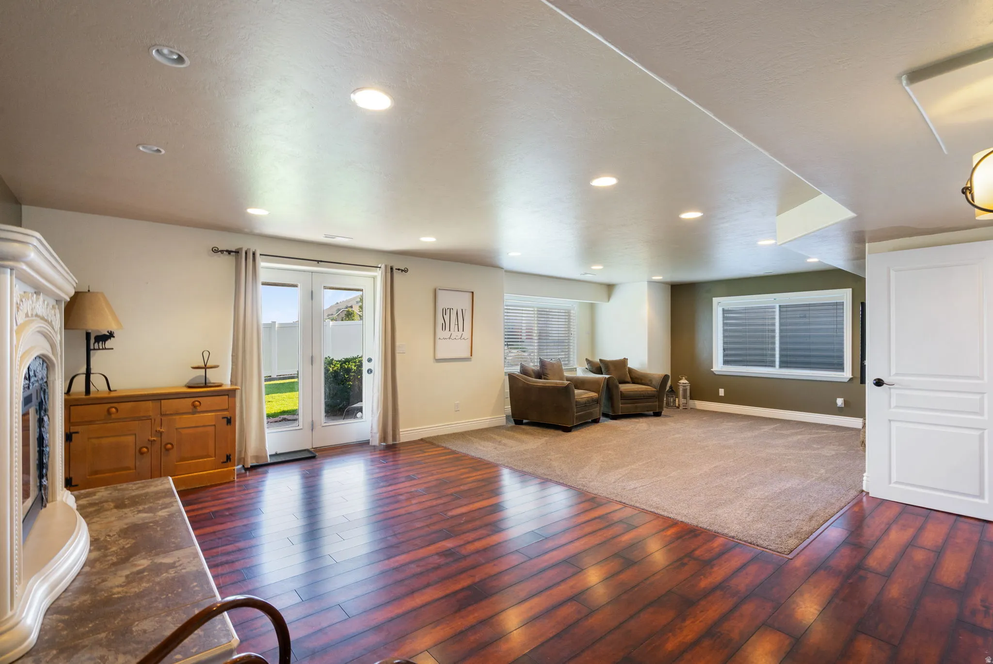 Hardwood-finish flooring, recessed lighting, white panel door, French doors, carpeted area