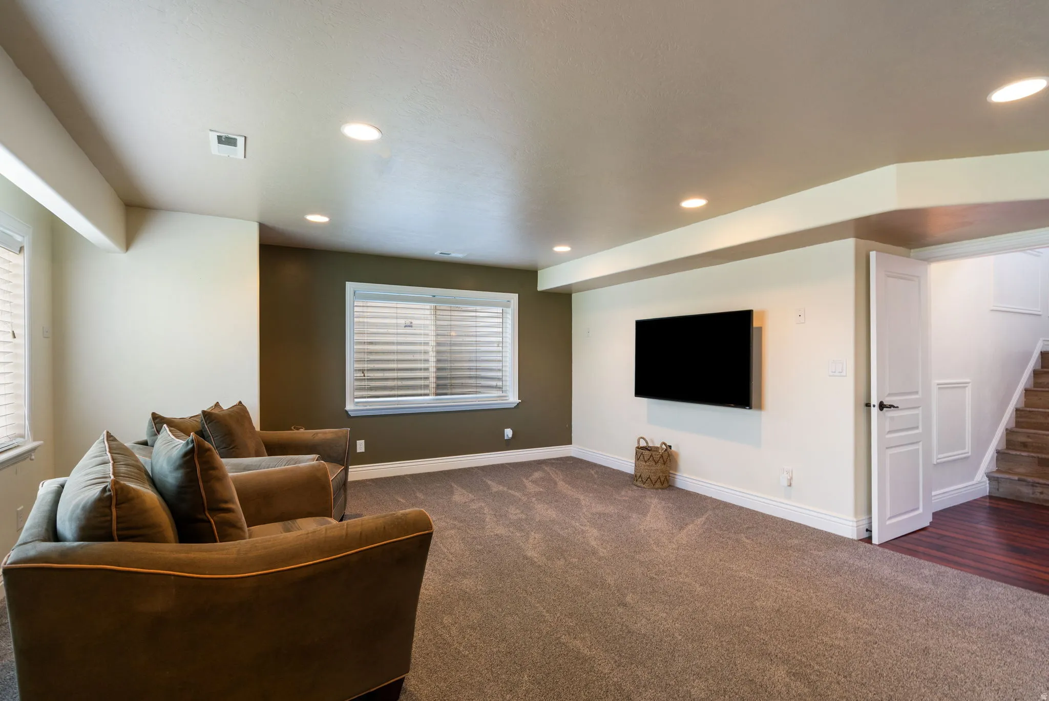 Recessed lighting, wood-finish flooring, two-panel interior door, and carpeted area