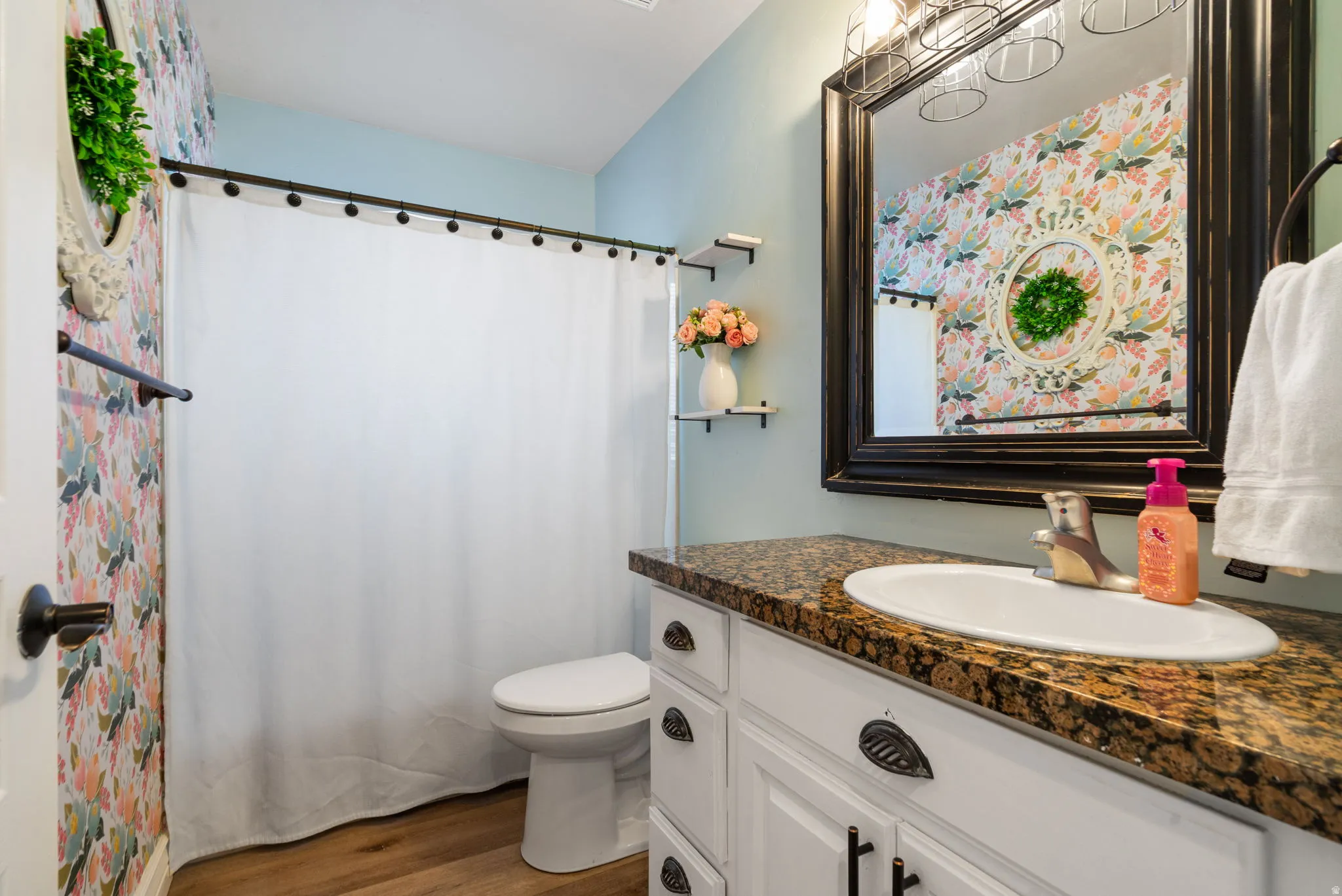 Vanity with an integrated sink, polished chrome faucet, and stone-finish countertop