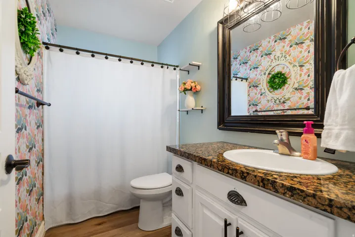 Vanity with an integrated sink, polished chrome faucet, and stone-finish countertop