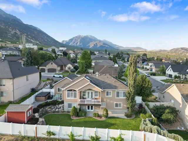 Elegant two-story residence featuring a cream-colored exterior with multi-pane windows and architectural detailing