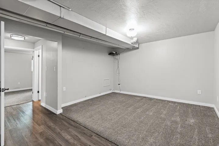 Spacious room with gray carpeting and light gray walls