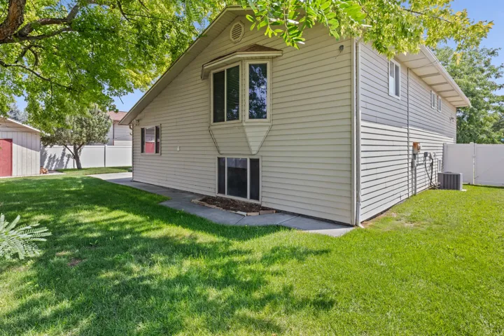 Charming two-story residence featuring neutral vinyl siding, multi-pane windows, and a covered front entry