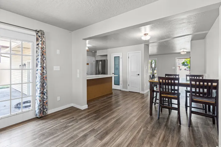Wood-finish flooring throughout, bright white trim, and recessed lighting
