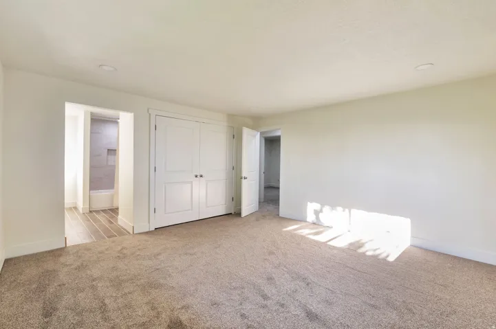 Recessed lighting, wood-finish flooring, white paneled doors, and neutral wall tones