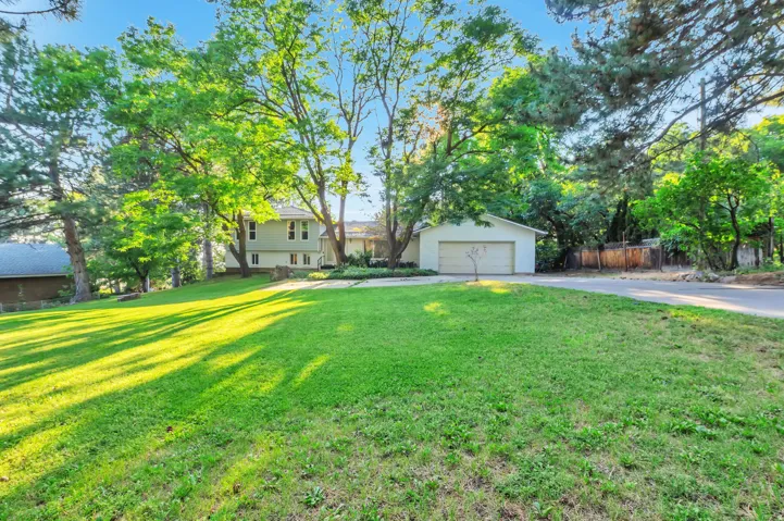 Spacious front yard with a lush green lawn