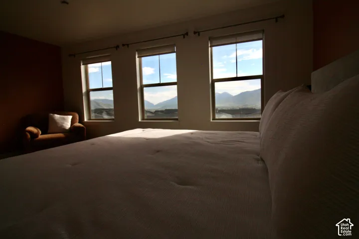 Room featuring three large windows with mountain scenery