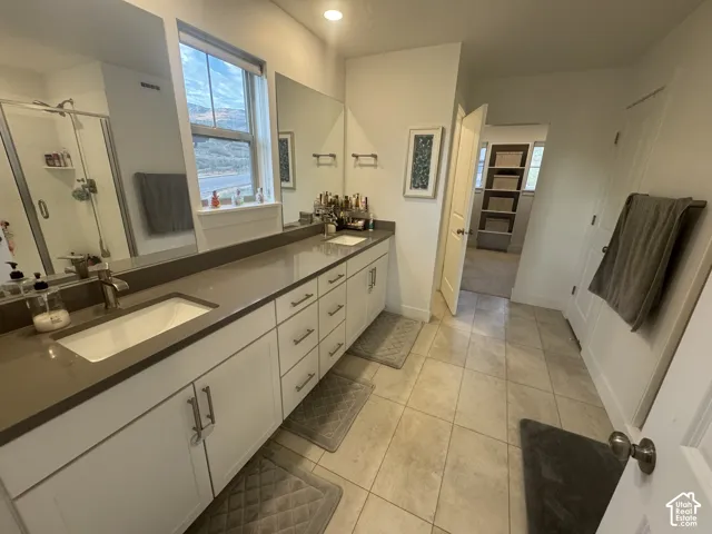 Dual sink vanity with white cabinetry and brushed nickel hardware