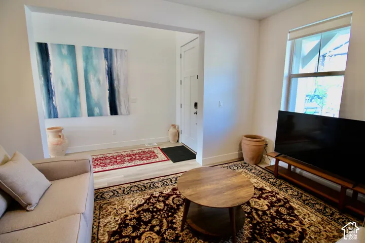 Open living area featuring light wood-finish flooring