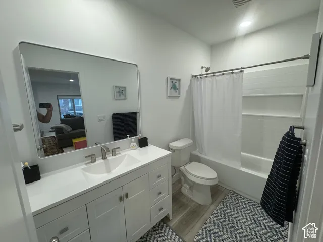Bathroom featuring a double-door vanity with integrated sink, white countertop, and brushed nickel fixtures