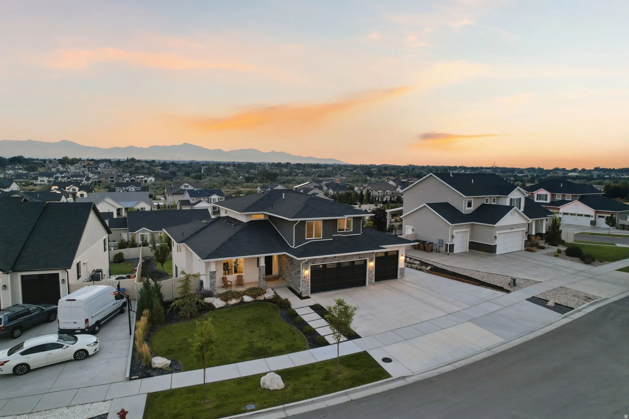 Modern residential estate showcasing a contemporary architectural design with a striking two-tone exterior featuring warm-toned siding and dark roofing