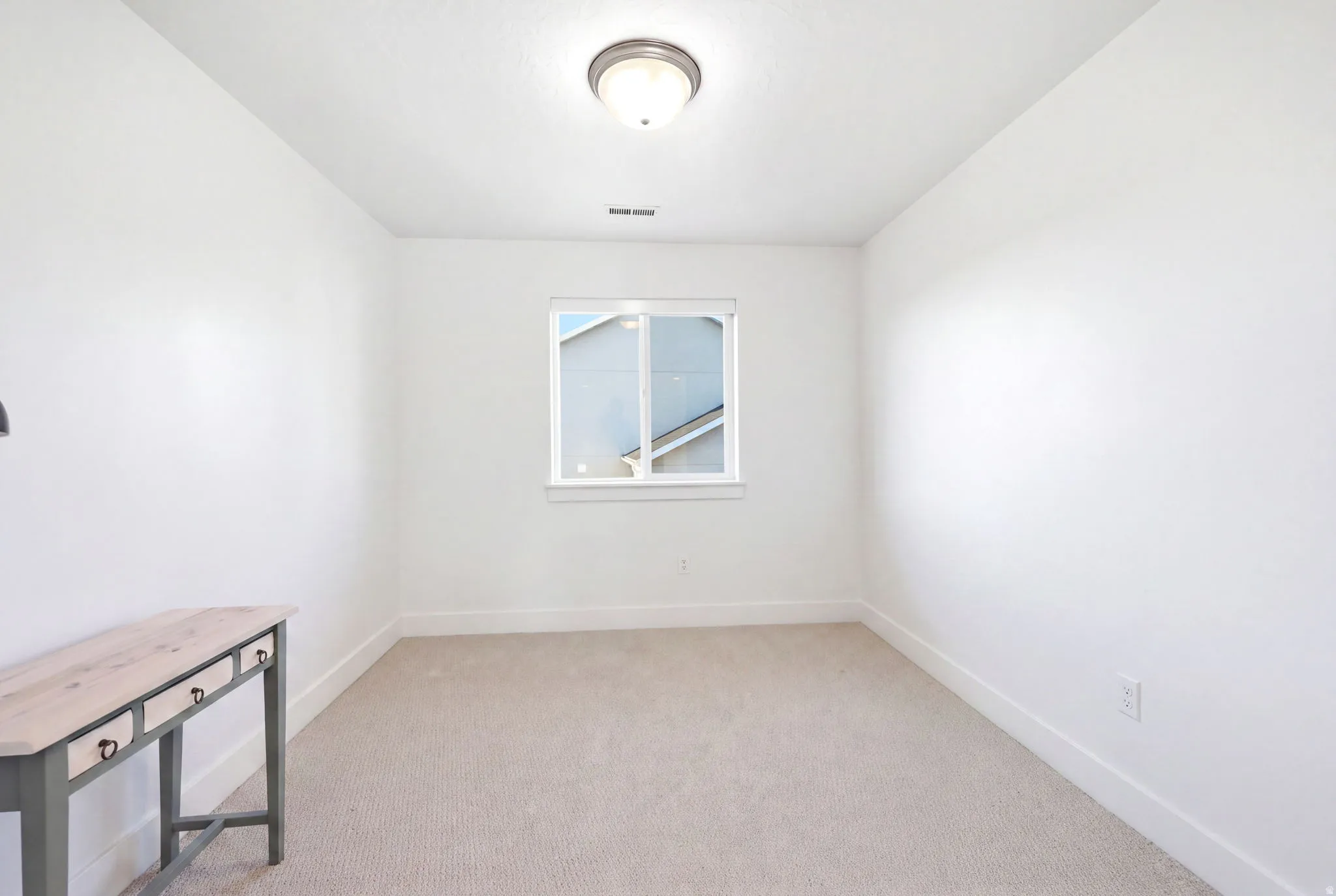 Neutral-toned carpeting paired with bright white walls