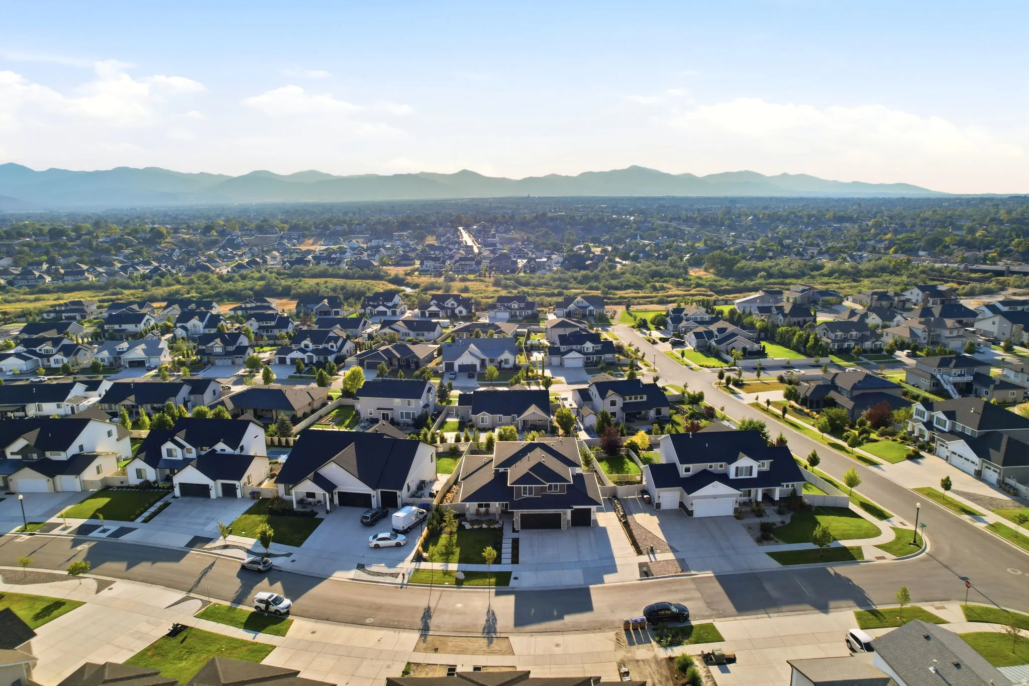 Expansive suburban community featuring tree-lined streets, established landscaping, and single-family homes with varied architectural styles
