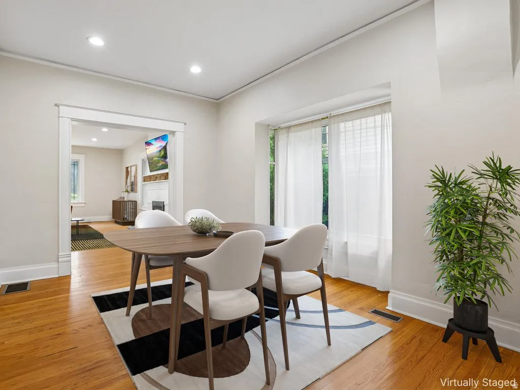 Hardwood flooring throughout, recessed ceiling lighting, and a large window