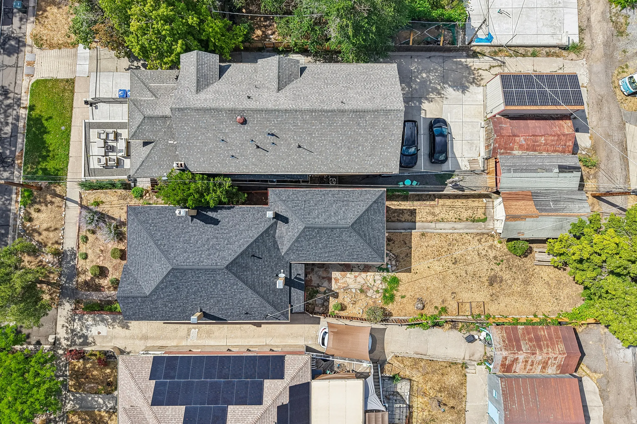 Two distinct residential structures with dark shingle roofing