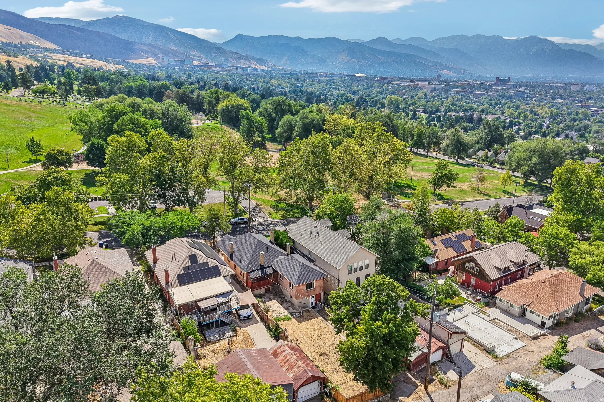 Aerial perspective showcasing residential properties with a mountainous backdrop