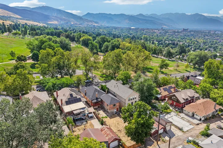 Aerial perspective showcasing residential properties with a mountainous backdrop