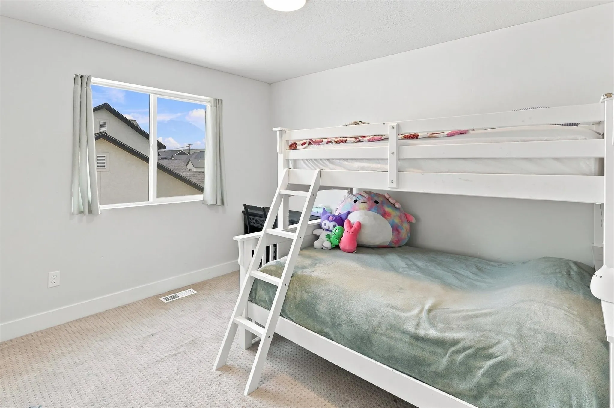 Room with light-colored carpeting, white walls, and a single window