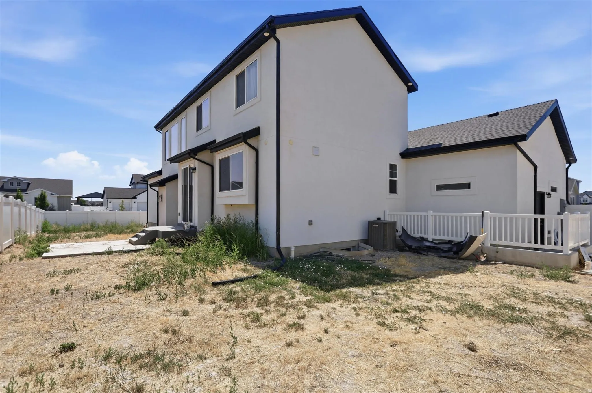Modern two-story residence featuring a clean, contemporary exterior with neutral-toned siding and dark trim accents