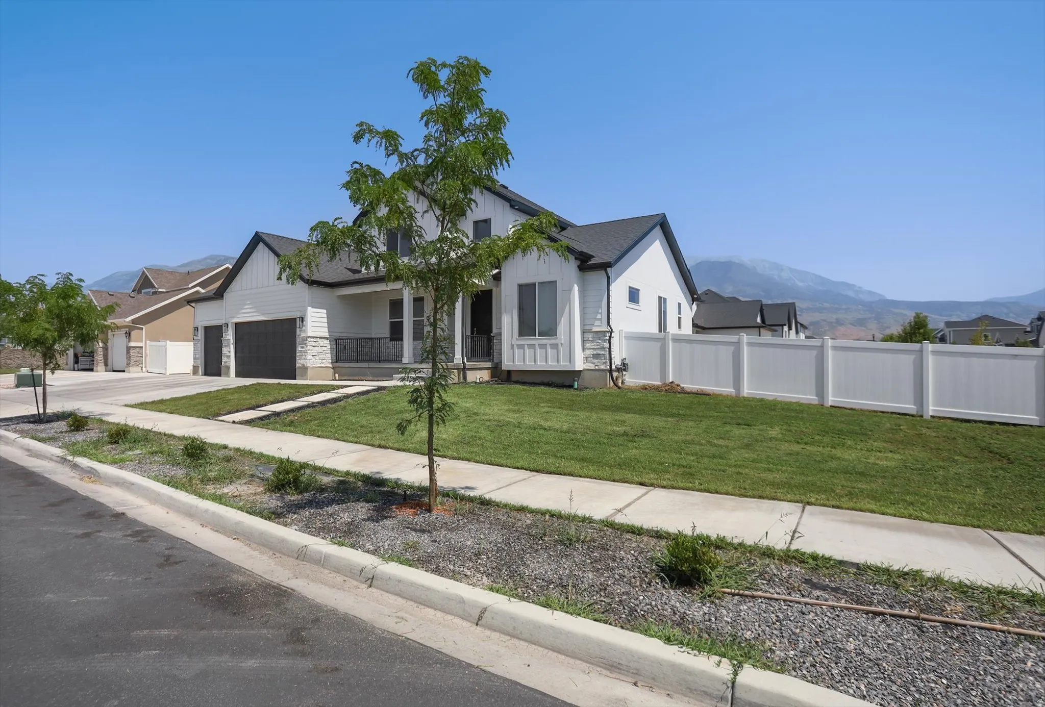 Modern residence featuring a clean architectural design with white exterior finishes and dark roof accents