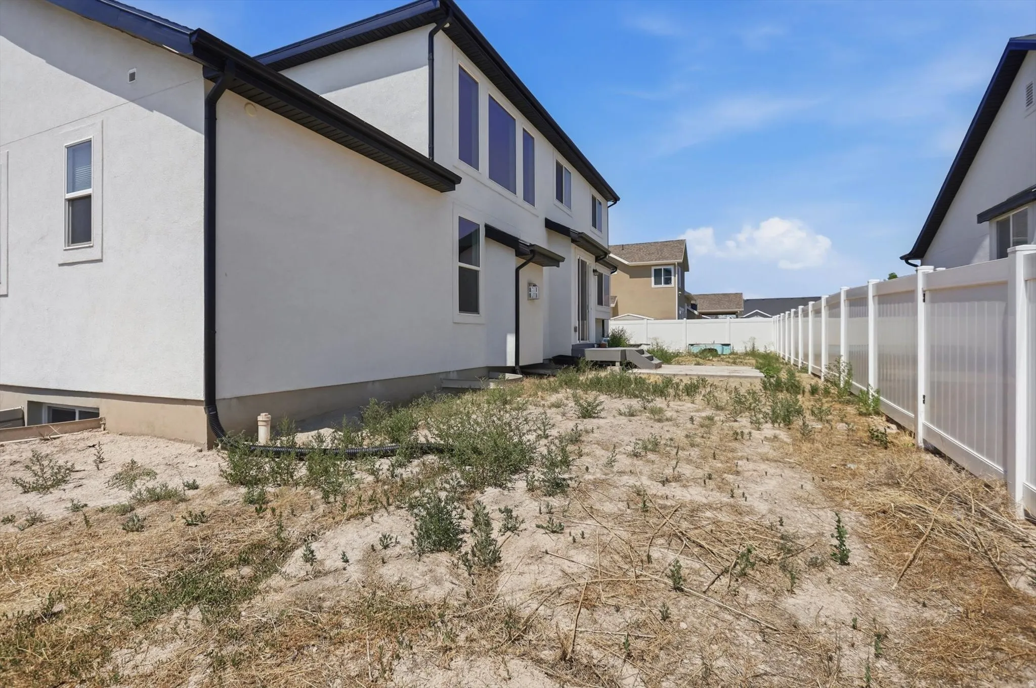 Newly constructed residence with modern exterior featuring clean-lined architecture and dark trim detailing