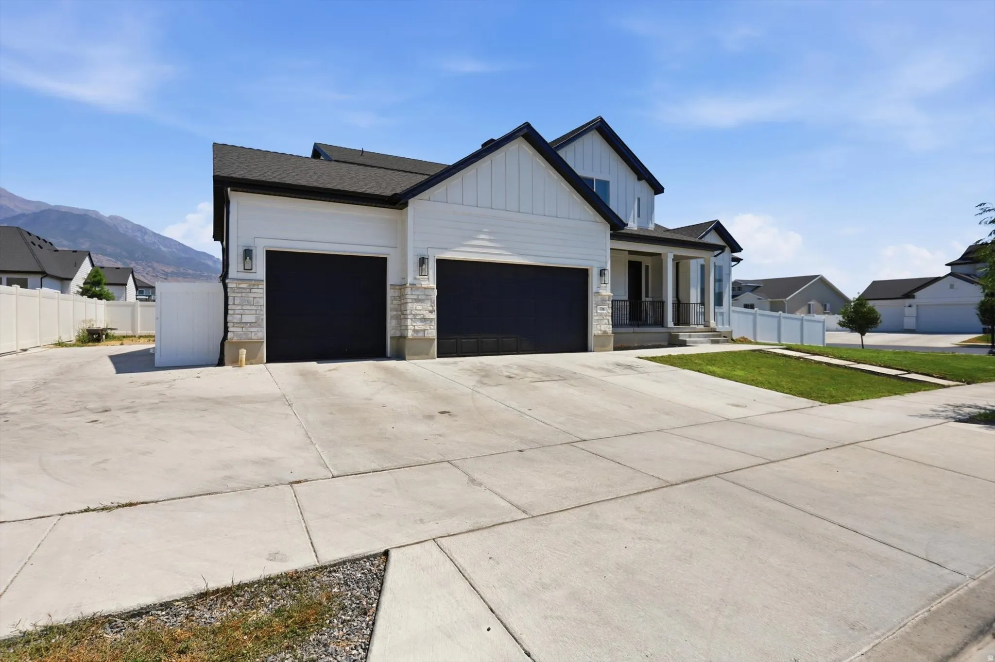 Contemporary exterior with white siding and dark trim