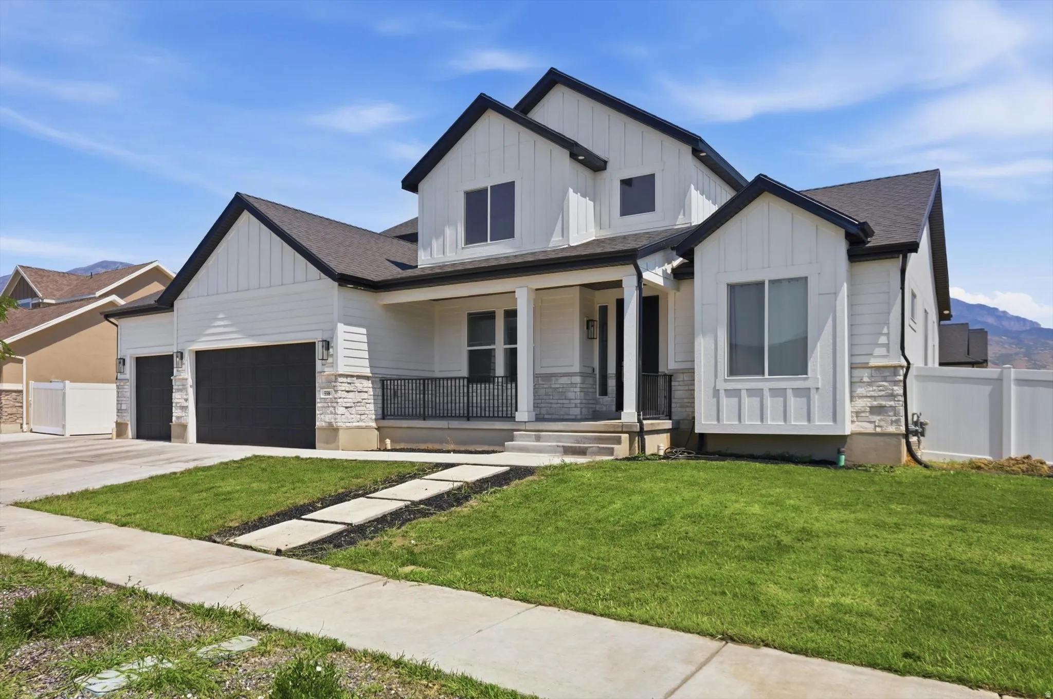 Modern farmhouse-style exterior with white siding and dark trim